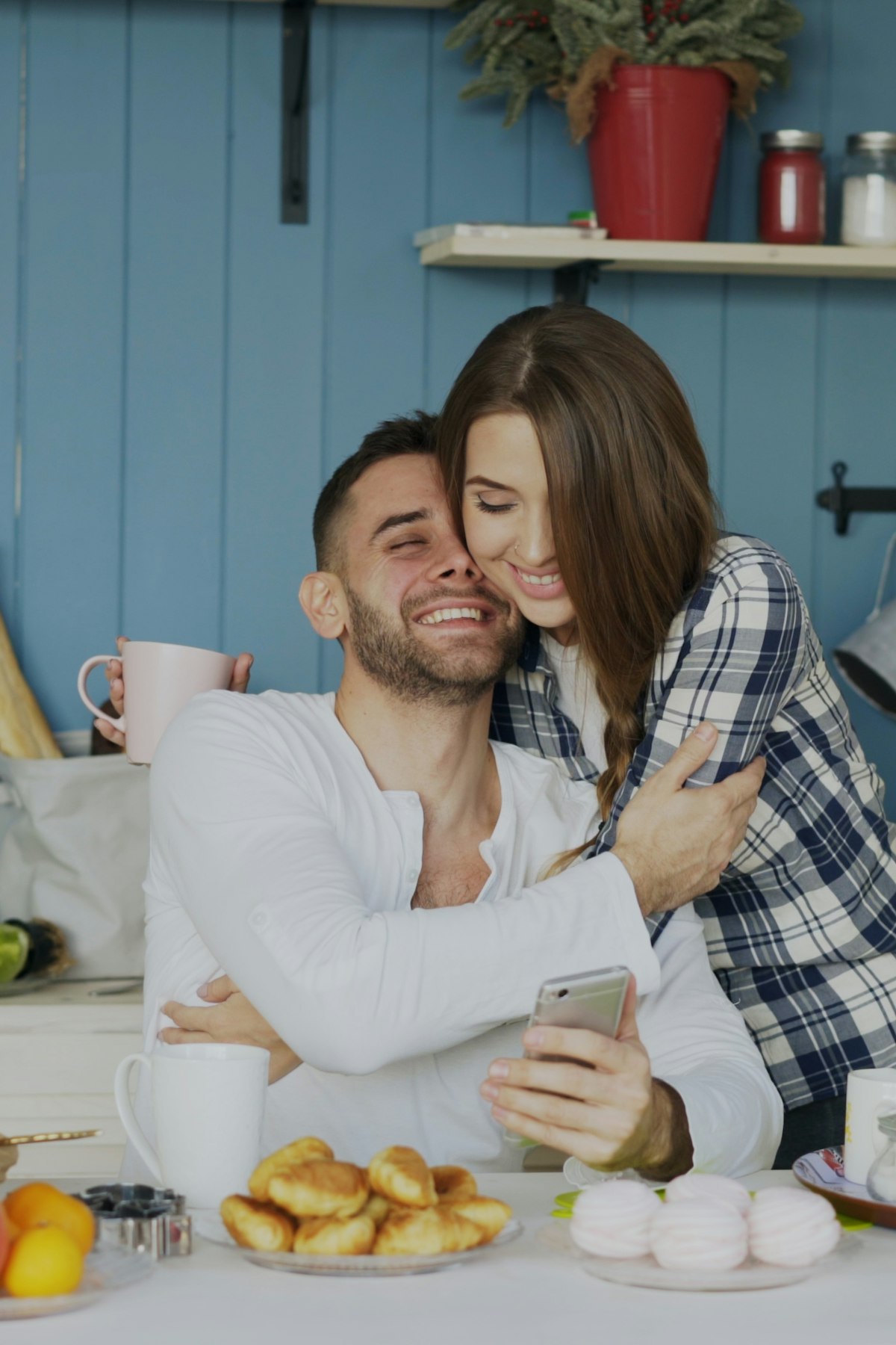Couple laughing together over coffee at home