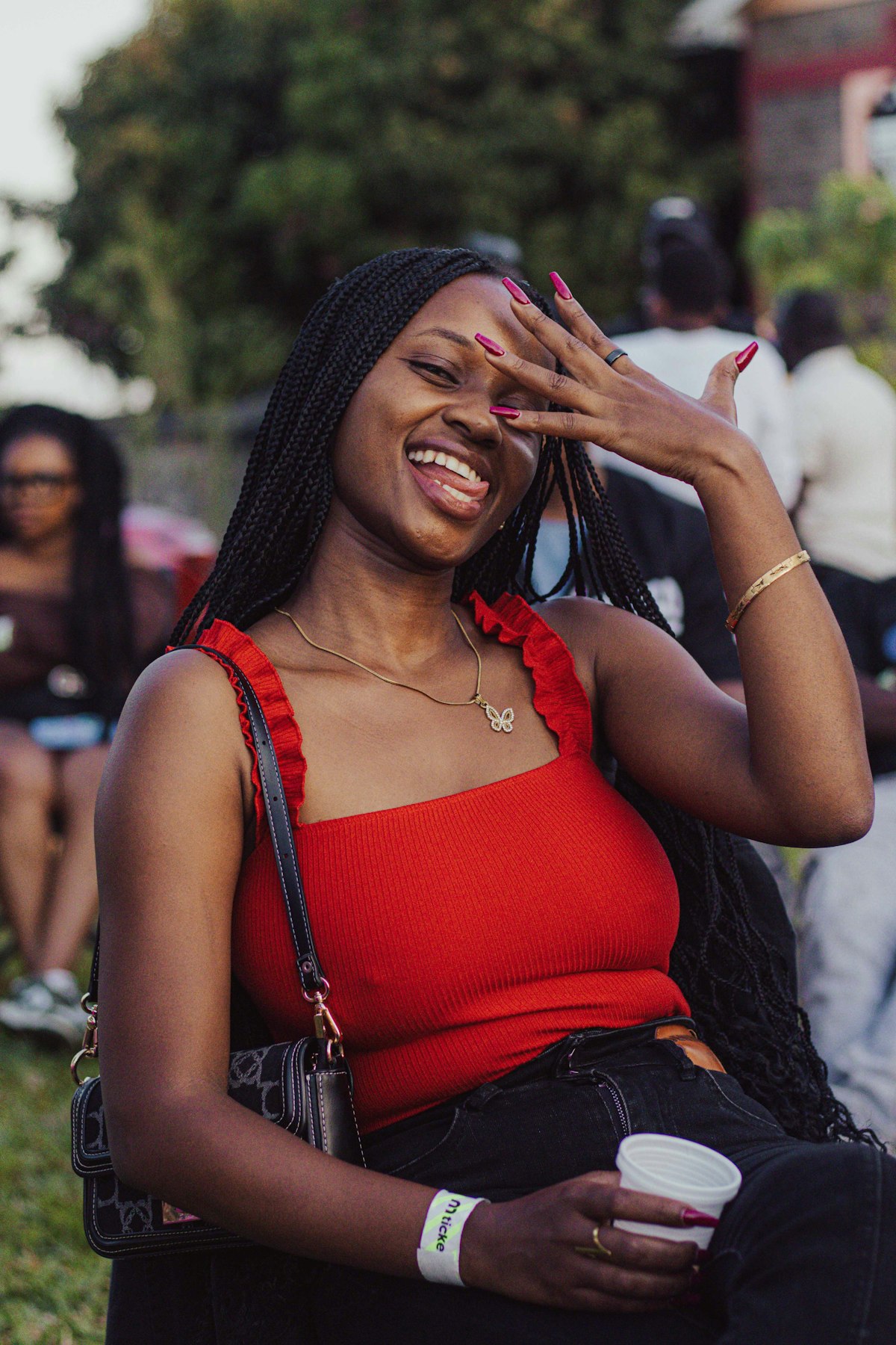 Woman laughing at an outdoor gathering