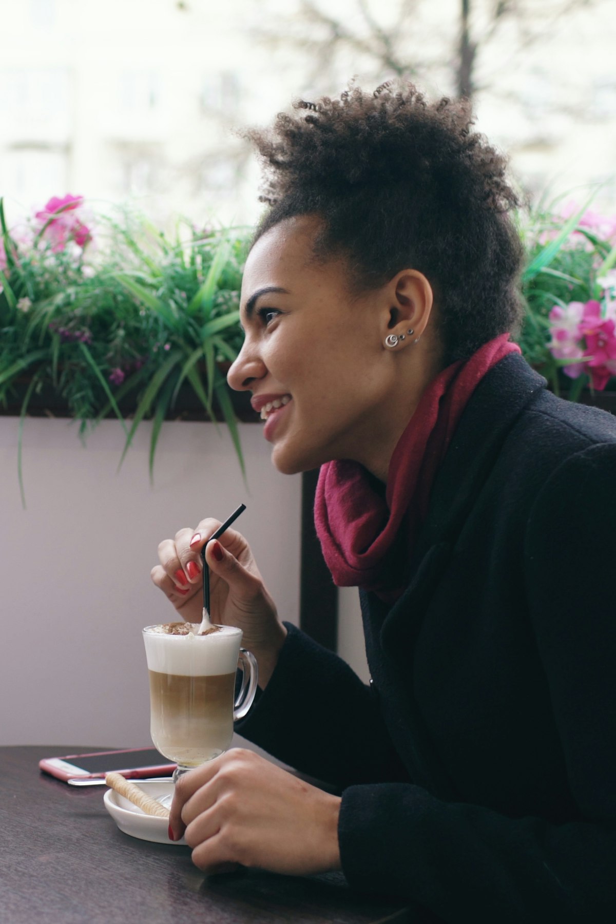 Woman smiling over coffee at a cafe