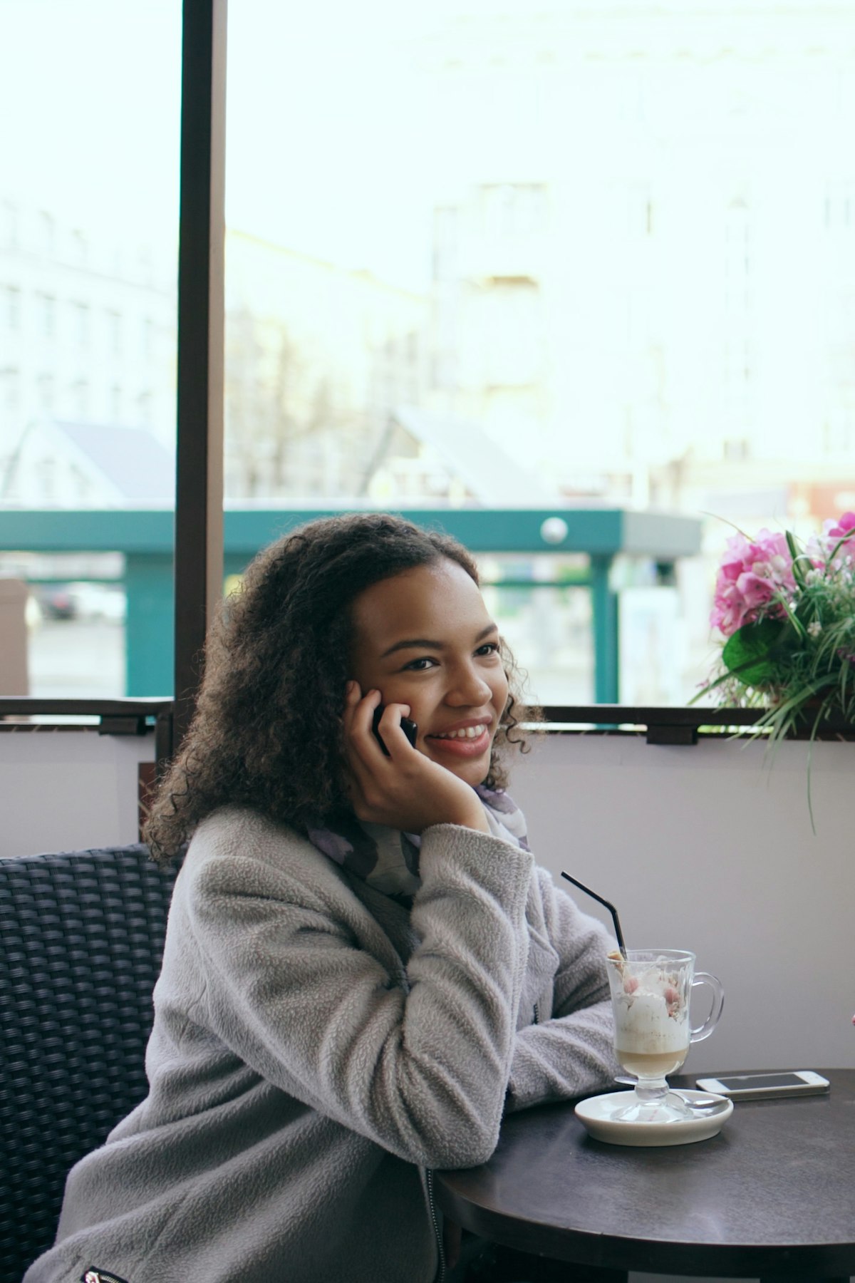 Woman on the phone at a cafe table